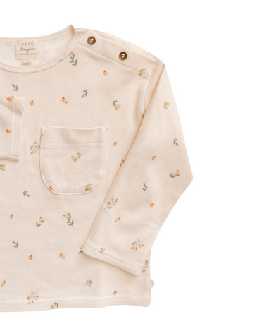 Image shows close up of organic cotton modal rib long sleeve tee in floral bud with Magnetic Button at neck. 