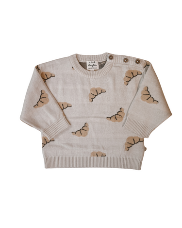 Flat lay image on white background of organic cotton knit croissant patterned sweater with Magnetic Button closures at the neck. 