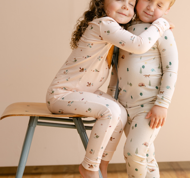 Image shows little girl wearing modal pajama set in birds print. 