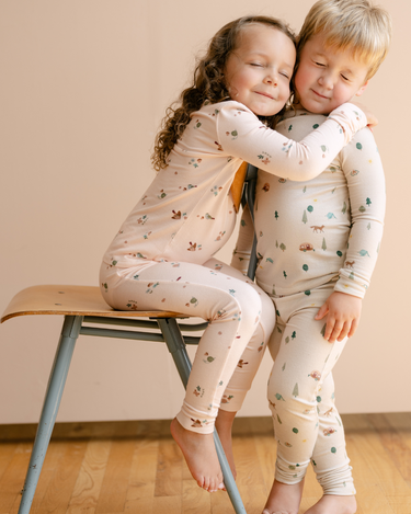 Image shows little girl wearing modal pajama set in birds print. 