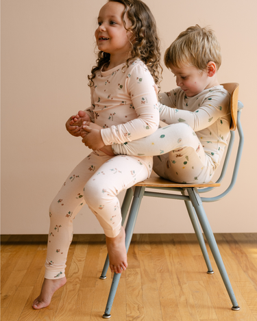 Image shows little girl wearing modal pajama set in birds print. 