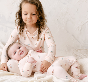 Image shows little girl wearing modal pajama set in birds print. 