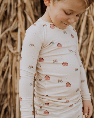 little boy wearing modal pajama set in farm print
