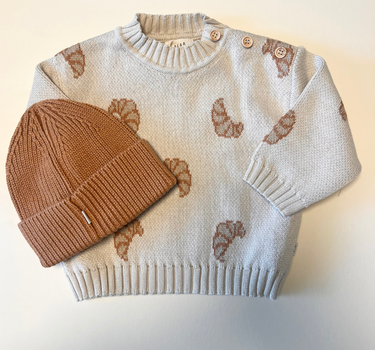 Image shows organic cotton knit croissant sweater with organic cotton knit beanie in acorn. 