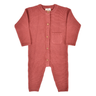 flat lay image of organic cotton garter stitch romper with magnetic closures from neck to crotch in rosewood pink color