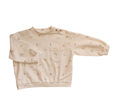 Organic cotton italian fleece sweatshirt in Paris print with magnetic buttons at shoulder and pocket on chest.