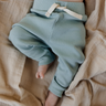 Organic Cotton Modal Rib Leggings in jade color on baby girl with faux drawstring