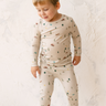 Image shows toddler boy wearing modal pajama set in camping print. 