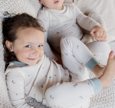 Image shows toddler girl wearing organic cotton modal rib toddler pajama set in floral bud. 