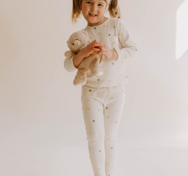 Image of little girl wearing organic cotton soft long sleeve tee in playground print with adorable pocket. 