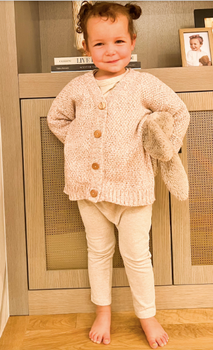 Image of little girl wearing organic cotton soft rose marble cardigan with Magnetic Buttons.