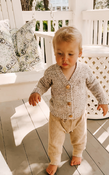 Picture of little boy wearing rhino gray organic cotton marble cardigan with Magnetic Buttons. 
